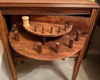 Front drawer swings out to hold bobbins and spools