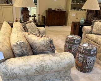 Vintage loveseats upholstered in toile 'village life' fabric