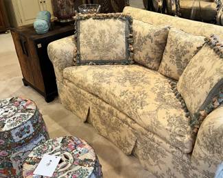 Vintage loveseats upholstered in toile 'village life' fabric