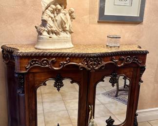 The alabaster carving and glass box are sold.