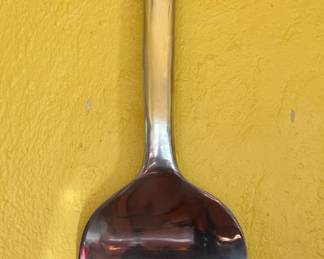 LARGE fork hanging on wall.