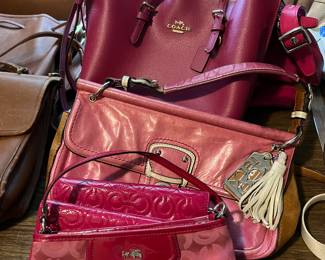 Designer purses, including many Coach