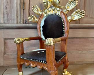 Pedro Friedeberg (Mexican, b. 1936)
Parcel gilt “throne” chair sculpture decorated with hands and crescent moons, upholstered with cow hide, signed on base