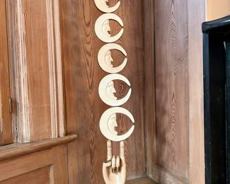 Pedro Friedeberg (Mexican, b. 1936) Painted and giltwood (totem) sculpture, graduated crescent moons on a footed hand, signed on base

