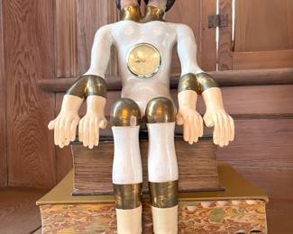 Pedro Friedeberg (Mexican, b. 1936)
Painted and giltwood double-headed seated figure with a clock in torso, signed on base
