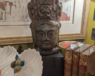 Buddha Head sculpture, antique leather bound books 