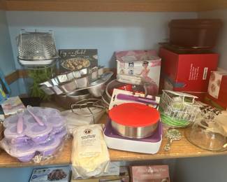 Small panty off kitchen with all cake decorating and baking, holiday pans, Swedish rolling pins, Two shelves and boxes on floor.