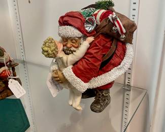 Vintage Santa picking up and hugging child