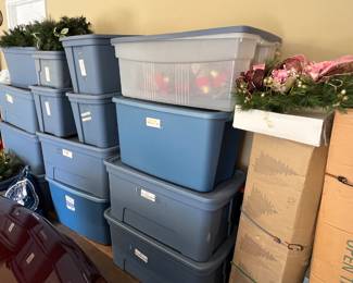 Holiday items still in bins, including 2 trees and several wreaths