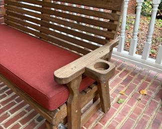 H27 - $200. 5' long Centerville Amish 800# treated porch glider with cushion. Has drink holder on each side - like new!