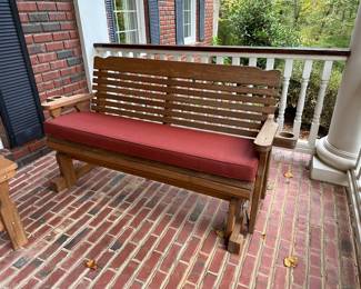 H27 - $200. 5' long Centerville Amish 800# treated porch glider with cushion. Has drink holder on each side - like new!