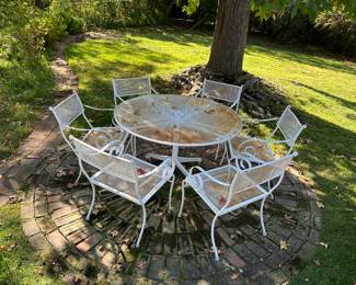 This is one of three rod iron patio sets on the property.  The other two are black and equally as beautiful.  Several piece of yard furniture pieces that you won't see in the photos. Please come to the sale and see it all.