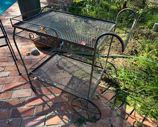 Old rod iron rolling yard cart.