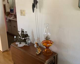 Vintage drop leaf table with four hidden chairs (tucked inside table), vintage amber oil lamp, vintage cuckoo clock