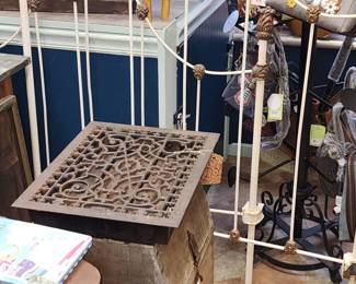 Victorian Twin Brass Finials on White Iron Bed, Side Rails.  Also very neat old  floor register damper. Under that is a Primitive onion-potato box.