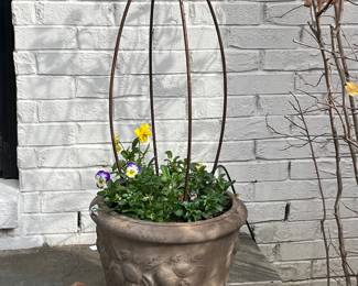 Antique French stone pots with topiaries and fresh flower plantings 