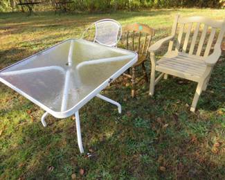 Lot 245. Three chairs and a glass-topped patio table