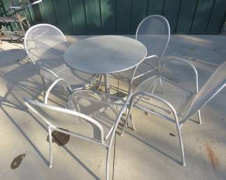 Lot 240. Metal patio table and four chairs. 28" diameter