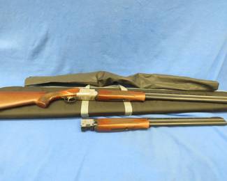 Lot 281. Mossberg Silver Edition over/under shotgun with an extra barrel. One barrel has two 12-gauge barrels and the other has two 20-gauge barrels. All have full choke tubes. SN: TR 12 095019
