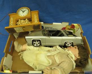 Lot 73. Porcelain doll, an electric mantle clock that works, and a remote-controlled car with no remote