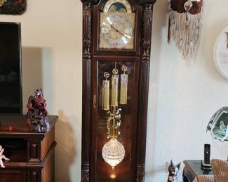 Fabulous Brookwood grandfather clock with crystal pendulum.  Has interchangeable discs for chimes and tunes