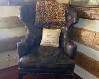 Leather wingback Chair, pillow,
throw, hunt scene prints 