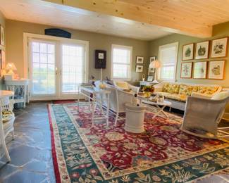 Large carpet, wicker sofas , wicker rocker , wicker and glass sofa table, lamps,  ceramic garden stools , prints