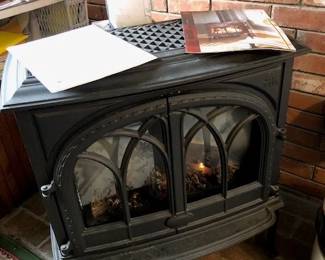 Jotul Cast Iron Gas Stove, includes owner's manual and two remote control units.