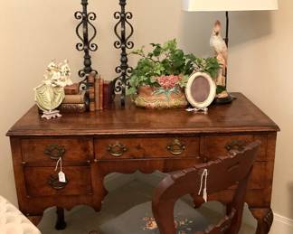 One of several desks; candleholders; lamp; chair