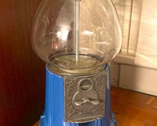 Coin- op bubblegum dispenser.