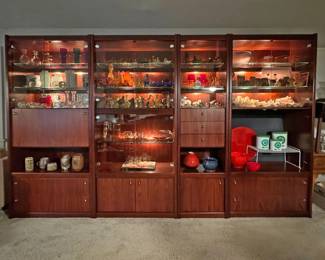 Mid Century rosewood wall unit, 4-sections, lighted interior includes a folding bar, drawer cabinets, glass doors.