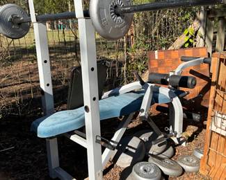 Outside in back of house - weight bench & weights