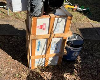 Outside in back of house - wood burning stove & accessories + the 2 wheeler it’s resting on!