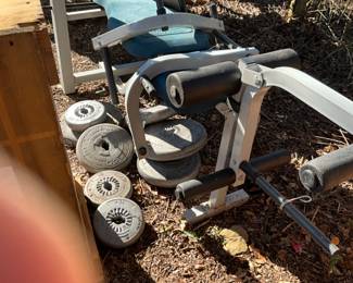 Outside in back of house - weight bench & weights