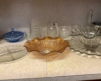 Glass platters, candle holders, blue glass candy dish, separated serving dish in kitchen