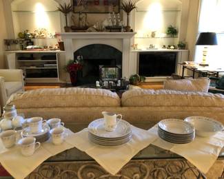 silk plants, framed wall art, curios, glass art, electronics, model ships, china, linens, beige sofa, entry way table, lamps, white armchairs