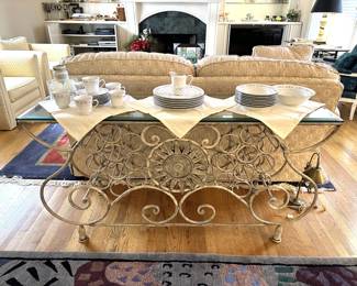 silk plants, framed wall art, curios, glass art, electronics, model ships, beige sofa, beige armchairs, entry way table, linens, china, area rugs