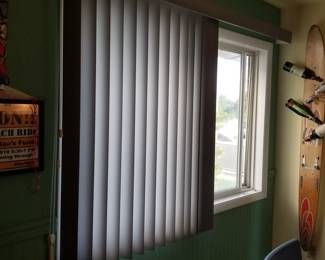 Sun-filtering shades and vertical blinds in a neutral gray throughout home