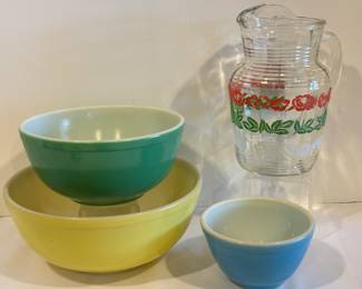 Three Vintage Pyrex Primary Colors Nesting Mixing Bowls & Mid Century Juice Pitcher. Items in good/used condition with some light wear. The pitcher measures about 9.5 inches tall.