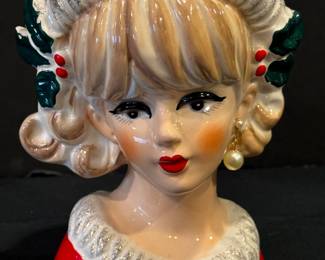 Vintage Napco Christmas Lady Head Vase. She is simply lovely with a red holiday trimmed hat and coordinating red coat.  The Napco sticker is missing. She measures about 7.25 inches tall and is missing an earring. 
