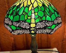 Dragon Fly Motif Stained Glass Table Lamp in gorgeous hues of green and yellow. 

Measures 17 inches tall. 