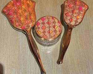 Vintage Three Piece Vanity Set including a lidded dish, brush and mirror that measures 13 inches in length. Light wear. 