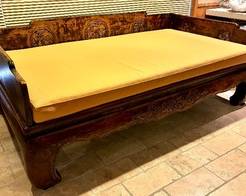 Antique Chinese Wood Opium Bed. Yes you read that correctly! An interesting piece of furniture to own. Features a curved carved apron paired with a lovely carved design surrounding the bed. The client was gifted this bed from a friend who had it shipped from China. The bed is original, 1800's and the cushion was custom made to fit the bed and is not original. 

Measures 93" x 56" x 33". 