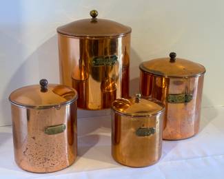 Four Piece Vintage Copper Canister Set. Includes; flour, sugar, tea and coffee ranging from 4.25" to 6.25" not including the lids. Items in used condition