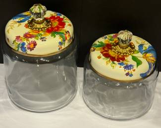 Two Mackenzie Child's Canisters each measuring about 9 and 11 inches with the lids.