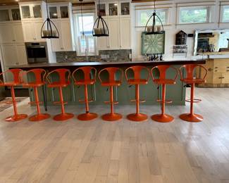 Set of 8 orange metal retro adjustable and swivel bar stools.