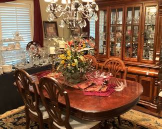 This beautiful dining table has leaves and a total of 8 dining chairs.
