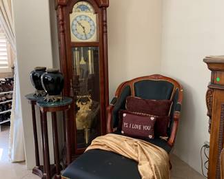 Cherry wood Grandfather's clock, chaise lounge, and marble and wood pedestals.