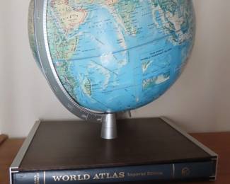 Vintage globe on world atlas.