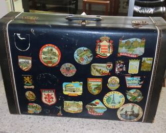 Vintage suitcase with travel decals.
